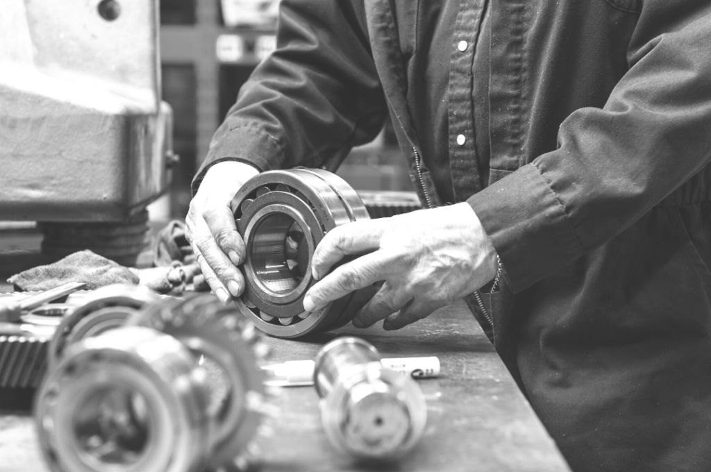 Man holding ballbearings in factory